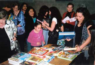 Fanilies get free books at School and Tutors on Wheels en of the year party