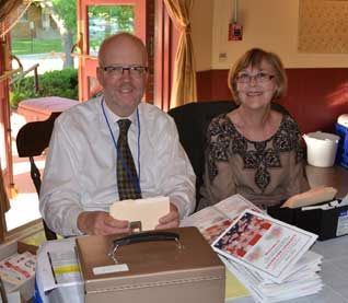 Board member Paul Jarosz checks guests in at Laugh for Literacy