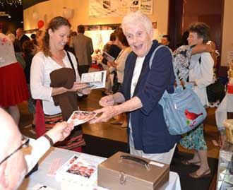 Sr. Pat Bolger, CSJ, gets her ticket for Laugh for Literacy