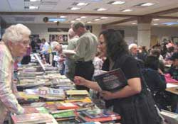 Sr. Janet Bolger helps her student choose from hundreds of free books at School and Tutors on Wheels party