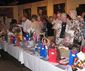 Guests examine raffle gift baskets